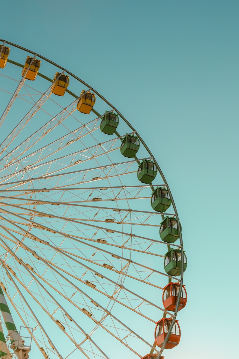 A large ferris wheel sitting next to a tall building
